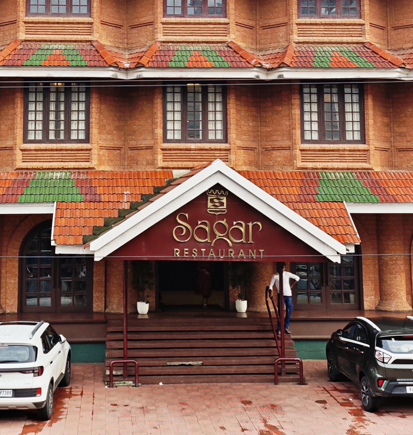 The Sagar Restaurant building on Mavoor Road — terracotta-tiled Kerala facade with the maroon and gold signboard