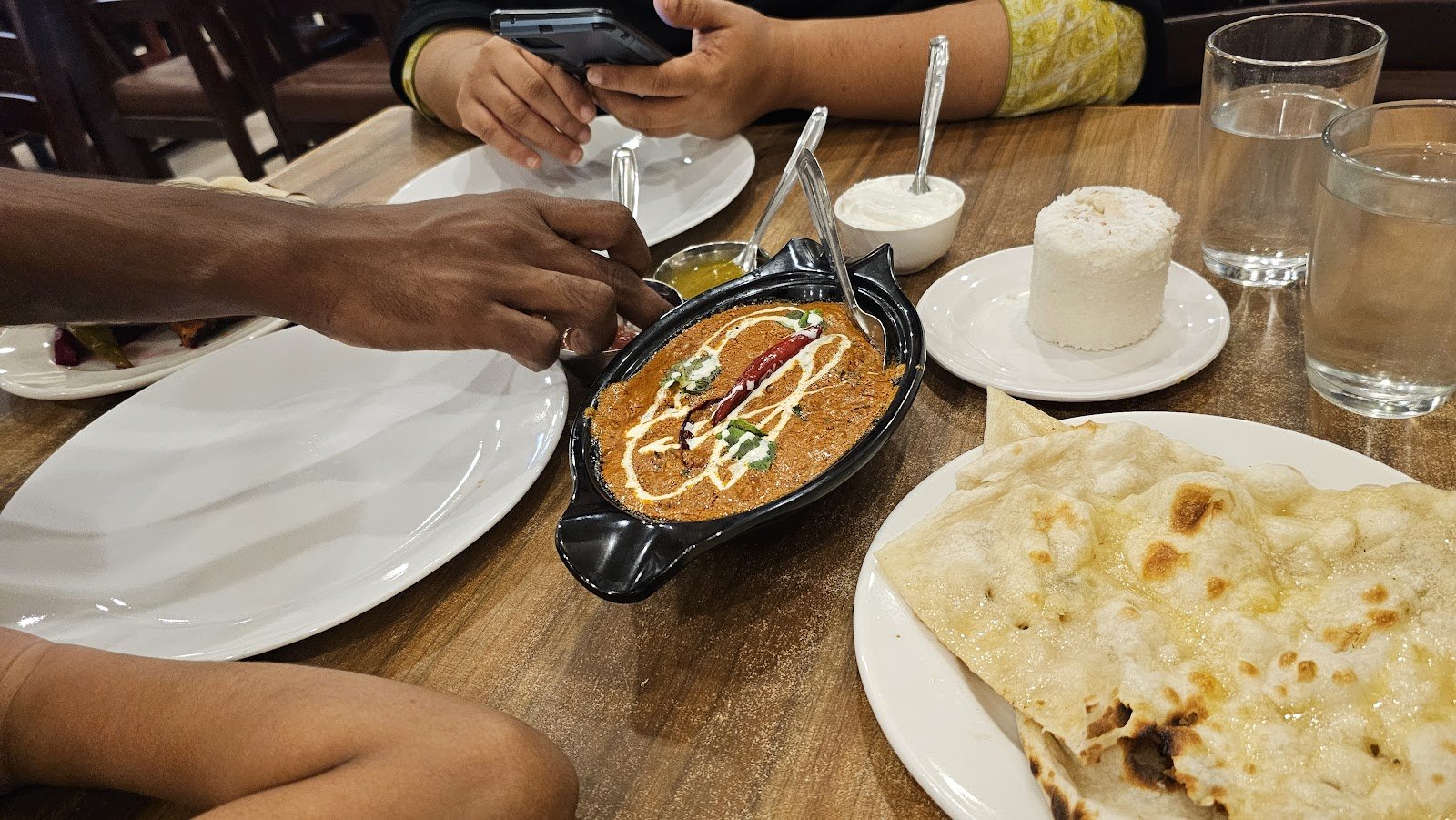 A Sagar table — curry, naan, puttu and water